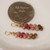 Mini Niihau shell earrings gift shown next to a coin for size comparison, Kahelelani shells in brown, green, pink and burgundy tones, small Hawaiian shell earrings under $100