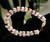 Authentic Hawaiian shell bracelet shown in side angle view featuring double-double Pikake tied shellwork with creamy Momi shells and colorful Kahelelani shell accents in soft ombre tones. Genuine Niʻihau shell jewelry bracelet inspired by traditional Hawaiian shell artistry. ハワイアンシェルジュエリー ニイハウシェル