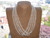 Traditional four strand Hawaiian shell necklace displayed on bust featuring genuine Laiki shells from Niʻihau with flowing layered shellwork and elegant natural off white tones.