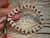 nibl_506
Close up ombre style ʻŪliʻuli Momi shell bracelet shown on hand before adding clasp, featuring rare blue ʻŪliʻuli Momi shells with brown Kahelelani shell accents. Photo highlights the quality of the shells, detailed workmanship, and balanced flow of shell colors and shell sizes throughout the bracelet.