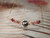 This 17" soft ombre Kahelelani shell necklace is shown hanging, featuring a 8.86 mm Tahitian pearl with soft silver undertones on a fancy Italian 14k gold filled chain.