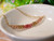 pd_608
Authentic Hawaiian shell necklace from Niʻihau displayed in a white dish featuring a delicate ombré arrangement of genuine Kahelelani shells with elegant minimalist coastal style.
