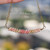 Lightweight tropical shell necklace hanging naturally to showcase the graceful curved shell arrangement and refined handcrafted island jewelry style from Niʻihau.