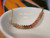 pd_615
Close-up overall view of the minimalist shell pendant resting inside a white ceramic dish highlighting the soft color flow, curved shell pattern, and detailed handcrafted workmanship of genuine Kahelelani shells from Niʻihau in green, Keʻokeʻo, red burgundy, and pink tones.