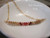 Close-up overall view of the floating shell pendant resting inside a white ceramic bowl highlighting the natural color flow, organic shell texture, and handcrafted arrangement of genuine Kahelelani shells from Niʻihau.