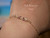 Very close-up wrist view highlighting the tiny handcrafted Kahelelani shells, delicate gold filled chain details, and soft everyday wear Hawaiian jewelry style created with shells from Niʻihau and Kauaʻi.