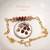Authentic Niʻihau shell bracelet displayed beside a dime on a white dish showing the tiny scale and natural beauty of genuine Kahelelani shells in keʻokeʻo, red burgundy, brown, and green tones accented with 14k gold filled chain. Delicate handcrafted Hawaiian shell jewelry with minimalist coastal style.