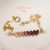 Authentic Niʻihau shell bracelet displayed on a white dish featuring genuine Kahelelani shells arranged in an ombré blend of mākuʻe brown, ʻulaʻula red burgundy, ʻākala pink, and keʻokeʻo off white tones accented with delicate gold filled chain. Elegant handcrafted Hawaiian shell jewelry with refined minimalist island style.