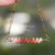 PD_724
Authentic Niʻihau shell necklace handcrafted with size 11 Kahelelani shells in keʻokeʻo off white, pink flower, brown, and deep red burgundy tones arranged in a soft ombre floating design on delicate 14k gold filled chain.