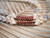 Detailed close-up of the handcrafted Poepoe Kahelelani shell section showcasing traditional Hawaiian shellwork on a genuine Niʻihau shell lei.