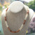 Handmade Kipona Style Hawaiian shell necklace displayed on a jewelry bust, showing how the bold yet elegant design looks when worn.