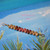 pd_758
Genuine Niʻihau Kahelelani shells in green, brown and pink flower colors arranged in a simple minimalist Hawaiian shell necklace design on a tropical blue background.
