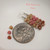 nier_3144
Handcrafted Hawaiian Kahelelani shell earrings with pink and green Niʻihau shells and chocolate Kauaʻi shells, shown beside a dime for size comparison.