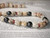 Detailed close-up of blue, brown spotted Onikiniki, yellow Lenalena, black spotted and white Momi shells paired with a lustrous 9–10 mm Tahitian pearl in authentic Hawaiian shell jewelry.