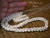 Niʻihau Momi shell Pikake lei and matching earrings #2023 shown with hand for scale