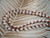 Close-up of single-strand Hawaiian shell lei with white Niihau Momi and burgundy Kauai Kahelelani shells #2030