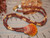 ninl_2031
Close-up of Hawaiian Kahelelani shell necklace with burgundy and yellow shells in Manuʻa Loa style surrounding a natural orange, yellow and reddish-burgundy sunrise shell