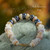 Handcrafted Hawaiian shell bracelet with iridescent Edison pearls, light blue, yellow and white Momi shells, and colorful Puka shell accents.