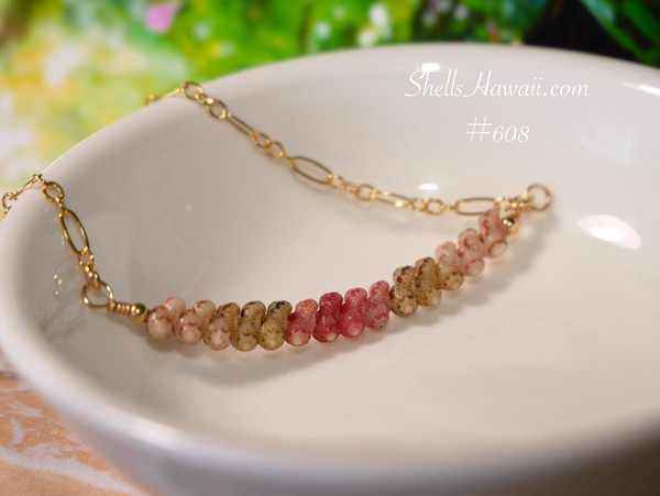 pd_608
Authentic Hawaiian shell necklace from Niʻihau displayed in a white dish featuring a delicate ombré arrangement of genuine Kahelelani shells with elegant minimalist coastal style.