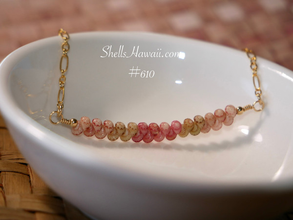 pd_610
Beach-inspired Hawaiian shell necklace displayed in a white ceramic dish featuring genuine Kahelelani shells arranged in a delicate minimalist curved floating design.
