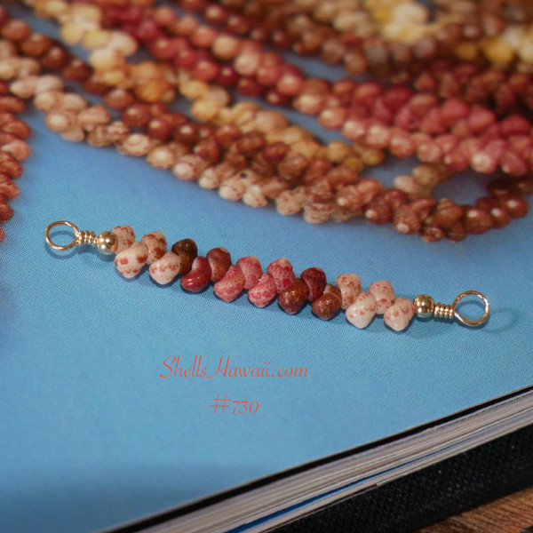 pd_730
Full view of a handcrafted 1" Hawaiian shell dainty floating necklace with 14K gold filled wire featuring Keʻokeʻo white, red burgundy, pink, and brown Kahelelani shells in a minimalist coastal style inspired by authentic Hawaiian shell jewelry.