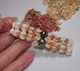 Close-up of Kipona style design showing cascading four strands of Momi and Kahelelani shells, colour gradation from yellow to natural tones, with Tahitian pearl and 14K gold-filled hooks adding polish.