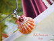 Pink, orange, and white Hawaiian sunrise shell pendant with authentic Niʻihau shells and Kahelelani flower accent