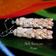 Close-up of four-strand Coconut design with alternating off-white and yellow Momi shells; elegantly layered strands giving volume and texture; sterling silver hooks for refined finish.