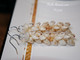 1¾″ Kipona style earrings featuring off-white Momi shells with soft light caramel and yellow hues accented by yellow Kamoa Kahelelani shells.