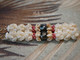 3" Niʻihau crown flower earrings handcrafted with genuine Momi shells, accented by deep red Kahelelani and finished with Tahitian pearls. Traditional Hawaiian crown flower design with a touch of elegance.