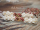 2 5/8" Niʻihau Momi crown flower earrings with Kahelelani shells in poepoe style, handcrafted with genuine shells in soft cream, pink, and tan tones. Traditional Hawaiian crown flower design with a delicate, airy look.