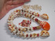 18½" Niʻihau shell lei, four-strand Kipona style, with rare Oʻahu Sunrise shell centerpiece and lustrous Momi & Kahelelani shells