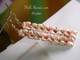 2¼″ Niʻihau Heliconia Flower style earrings handcrafted with yellow Lenalena Momi shells and vibrant Kahelelani accents in pink, green, chocolate, and dark pink tones. Bold tropical artistry.