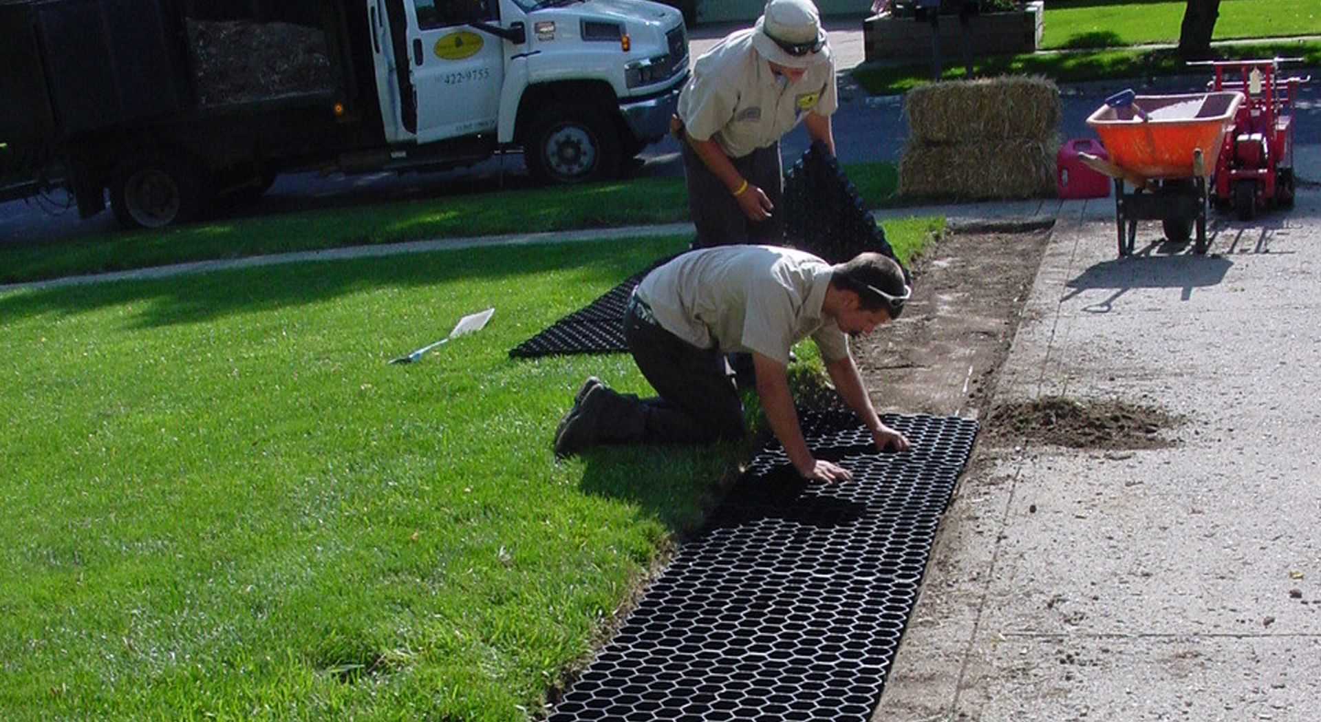NDS Grassroad grass pavers installed next to a residential driveway, offering a permeable green surface for vehicle access and stormwater management