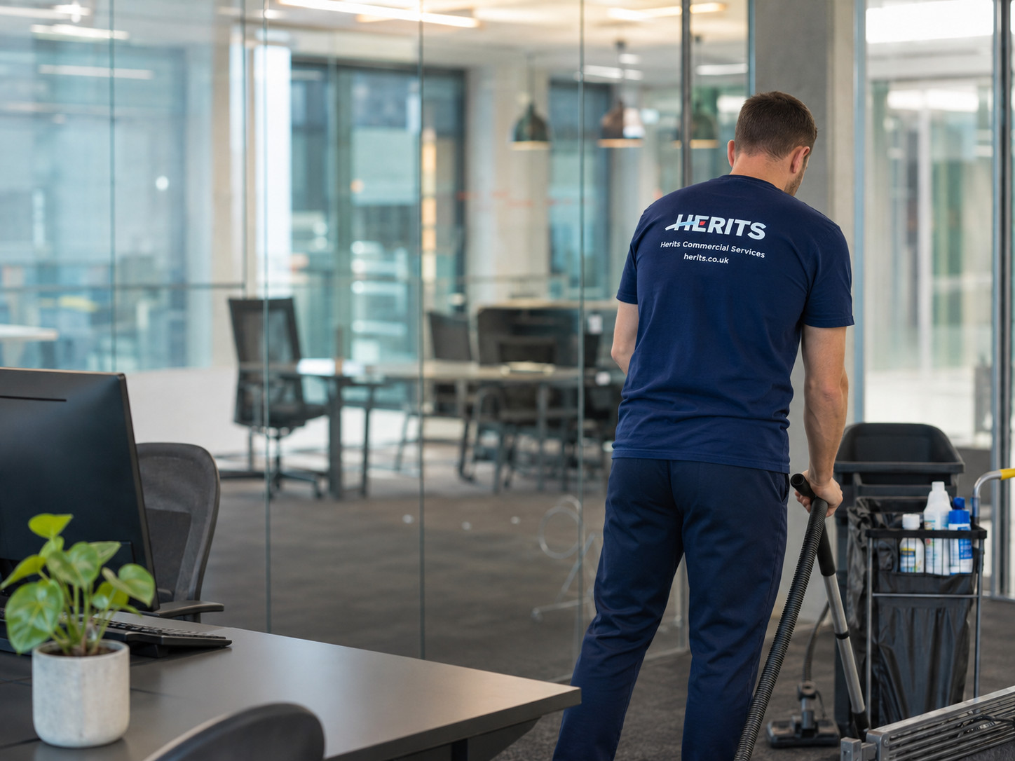 Herits employee carrying out general cleaning in a commercial workplace