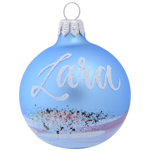 christmas bauble with wintery tree covered in snow