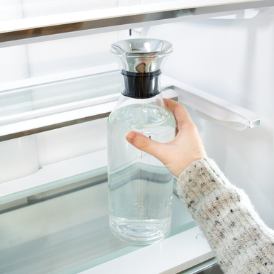 Sharp French 4-Door Refrigerator (SJG2351FS) – interior view of slide-in shelf with water bottle