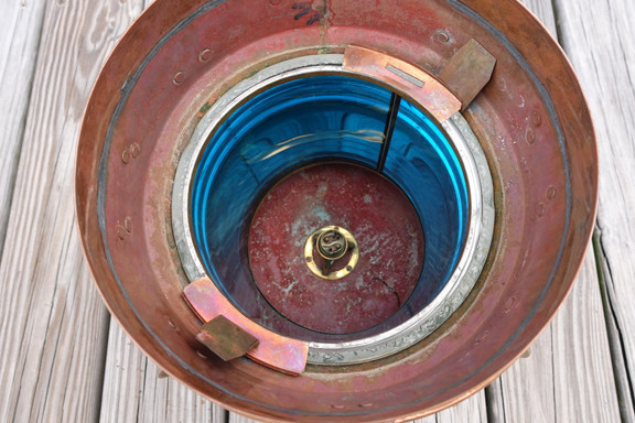 green insert inside copper ship light