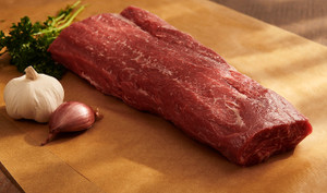 Pictured is an uncooked Linz Heritage Angus Reserve heart of ribeye roast on a cutting board