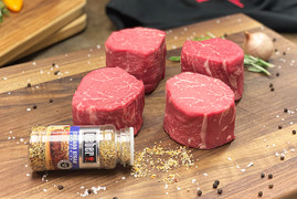 Pictured is 4 uncooked Linz Heritage Angus choice filet mignons and Weber Grill seasoning on a cutting board.