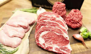 Pictured are 4 uncooked Linz Heritage Angus ribeye steaks, 2 lbs of angus ground beef, 8 chicken breasts on a cutting board.