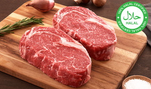 Pictured is 2 uncooked Halal Linz Heritage Reserve Angus boneless ribeyes on a cutting board.