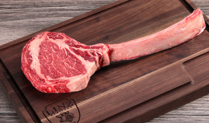 Pictured is an uncooked Linz Heritage Angus reserve tomahawk ribeye on a cutting board.