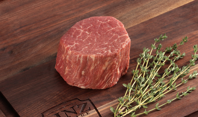 Pictured is an uncooked Linz Heritage Angus Reserve filet mignon on a cutting board