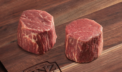 two uncooked Petite Tenderloin Filets Linz Heritage Angus Reserve on cutting board