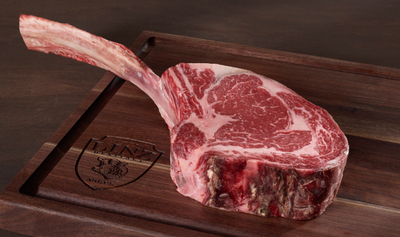 Pictured is one uncooked Linz Heritage Angus dry aged reserve tomahawk ribeye on a cutting board
