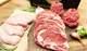 Pictured are 4 uncooked Linz Heritage Angus ribeye steaks, 2 lbs of angus ground beef, 8 chicken breasts on a cutting board.