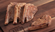 Pictured are 4 cooked Linz Heritage Angus Reserve Tenderloin Filet chops on cutting board