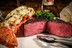 Pictured is a cooked Linz Heritage Angus filet mignon cut in half and a Maine lobster tail on a plate.