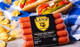 Pictured is a pack of Linz Heritage Angus beef franks on a blue picnic table cloth